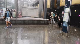 Downpour in London sends some scurrying