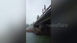 Flash flood gushes through river in Philippines while youngsters enjoy swimming