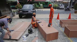 Public Infrastructure and Facilities Officers (PPSU) prepares coffins for the coronavirus disease victims