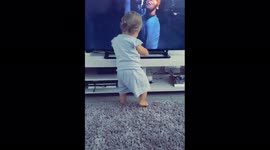 Baby girl loves dancing to her favourite song in front of the TV