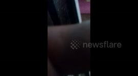 A large stream of water washes away the wall in the street in Atizapán, México