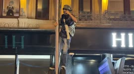 Fans climb on post in Leicester Square while celebrating Euro2020 win