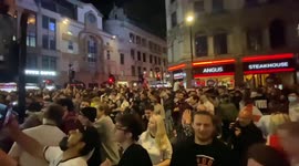 Piccadilly Circus blocked as fans climb phone booths and traffic lights