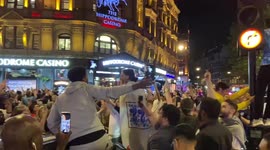 England football fan climbs a lamp post as crowds celebrate England’s win over Denmark in the Euro 2020 semi-final
