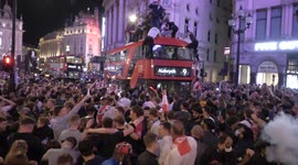 London ERUPTS with fans climbing on buses as England celebrate football win