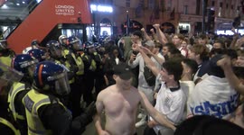 England fans clash with riot police and throw PUNCHES at one another after football match win