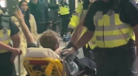 Police in Piccadilly Circus get fireworks, bottles and cones thrown at them after England's semi-final win