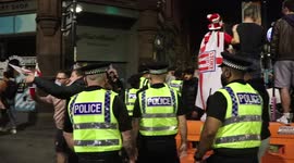 Police walk into celebrating crowd of England fans to stop them collapsing a bus stop & getting hurt. In Manchester city centre following their victory over Denmark