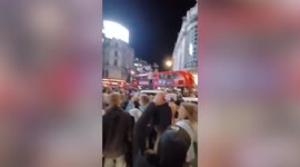 England fans climb on double-decker bus in Piccadilly Circus during Euro 2020 celebrations