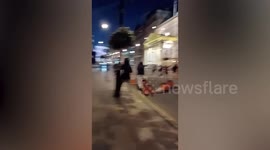 England fans kick traffic cones during Euro 2020 celebrations in Leicester Square, London