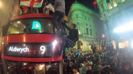 England fans hang off double-decker bus in London after semi-final win over Denmark