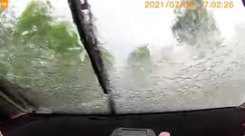 Car narrowly avoids crashing into scooter in China after motorist's view blocked by water on windscreen