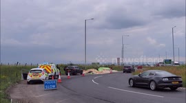 Lorry sheds its load of planks at a busy roundabout in Kent, UK