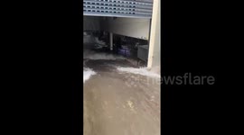 Torrent of water floods underground parking in Perth, Australia, after severe storm