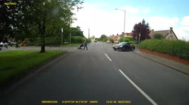 Dash cam footage of a Lexus Driver joining a main road with Mastiff? dog almost half way out of car window as pram pusher casually crosses road