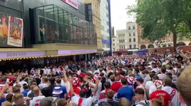 Huge England fan crowd in West End hurl bottles at fan standing on cinema roof