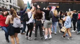 Busker does brisk business as football fans in Leicester Square dance to fan tunes