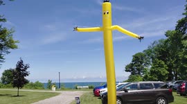 Giant Yellow Arm Flailing Balloon Man at Lake Erie in Ohio during the Summer Close-Up