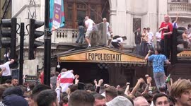 England fans SWING from traffic lights in London as team get ready for Final against Italy