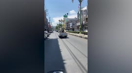 Three dogs cruise on the back of pick up truck in Thailand