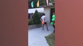 Adult men play bizarre balloon popping relay game using their crotches