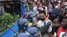 England fan gets glass bottle to the head as football fans clash with police at Trafalgar Square in London during Euro 2020 final