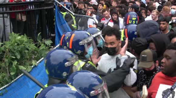 England fan gets glass bottle to the head as football fans clash with police at Trafalgar Square in London during Euro 2020 final