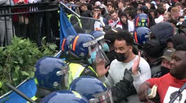 Riot police come under heavy missile fire whilst preventing unticketed England fans from entering the Trafalgar Square fan zone in London during Euro 2020 final between England and Italy