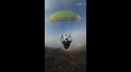 Paraglider descends through clouds as he jumps from mountain in California, US