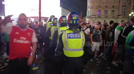 Riot Police clear crowds from Piccadilly Circus and come under attack from bottles being thrown