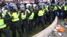 The moment an England fan gets glass bottle to the head as football fans clash with police at Trafalgar Square in London during Euro 2020 final