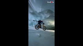 Cyclist pedals through stunning glacier cave in Switzerland