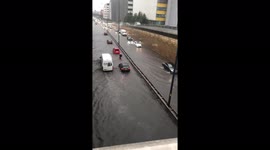 Vehicles struggle to drive through London streets submerged by floodwater