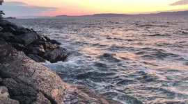 Tide Brings Waves Crashing to Short During Summer Sunset in Trondheim Norway