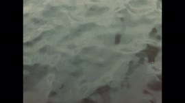 Closeup View of Gentle Ocean Waves Moving at Twilight in Norway