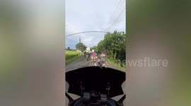 Truck carrying huge cargo caught on hanging power lines in Indonesia