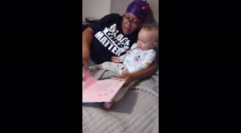 Mom and baby girl read book