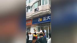 Chinese residents use curtain to catch boy falling from building