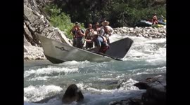 Skilled Whitewater River Guide Rows Wrecked and Twisted Driftboat Through Dangerous Rapids in Idaho Wilderness