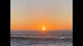 Orange California Sunset with Waves Filmed at Morro Bay Rock Park in