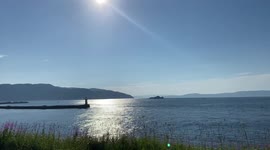 View of Fjord with Wavy Water and Boats on Sunny Nordic Summer Day