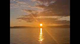 Straight On Sunset View of Orange Midnight Sun in Trondelag Norway