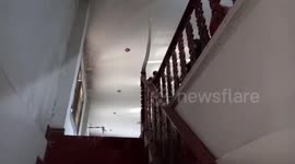 Huge python snake found wrapped around wooden stair bannister in Thailand