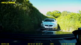 Oncoming vehicle nearly causes an accident down a small country lane.