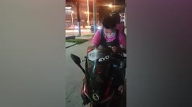 Food delivery rider sings using portable karaoke while waiting for order