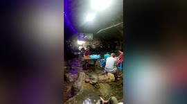 Tourists watch film and escape heat inside cool cave in eastern China