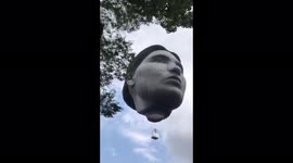 Giant face-shaped hot air balloon floats over Tokyo