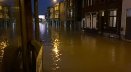 Belgium flooding: Neighbors are discussing in a completely flooded street of Wavre, Belgium