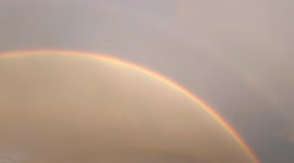 Perfect rainbow on a mountain background appears in countryside of Almaty