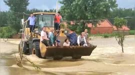 Forklift used to transport villagers trapped in deep floodwater in China